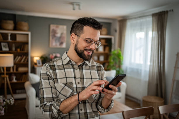 istock A handsome man at home is scrolling through social networks 2163642214