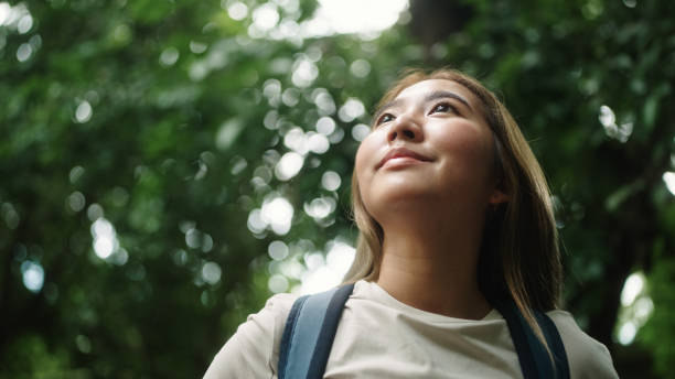 Asian woman enjoying view in nature.