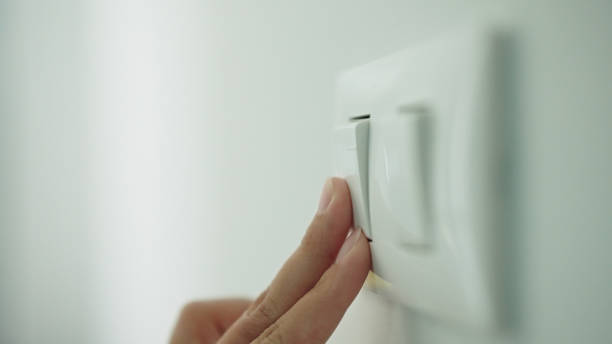 istock Turning on off room electric light wall switch pushing button. 2163644187