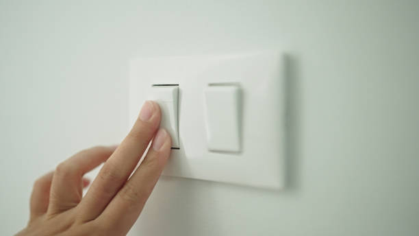 istock Turning on off room electric light wall switch pushing button. 2163644194