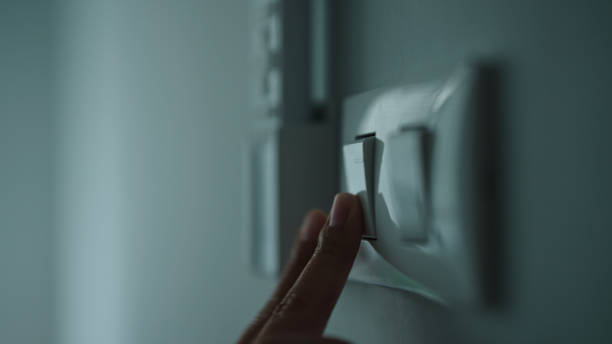 istock Turning on off room electric light wall switch pushing button. 2163644214