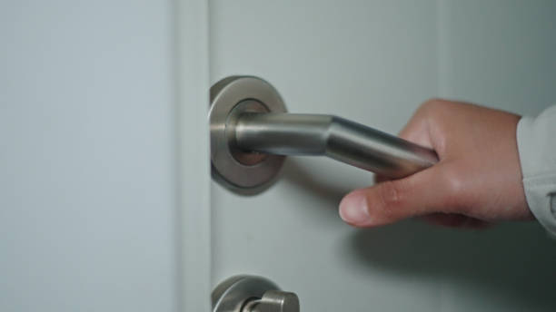 istock Hand holding a door knob and opening go to inside. 2163644261