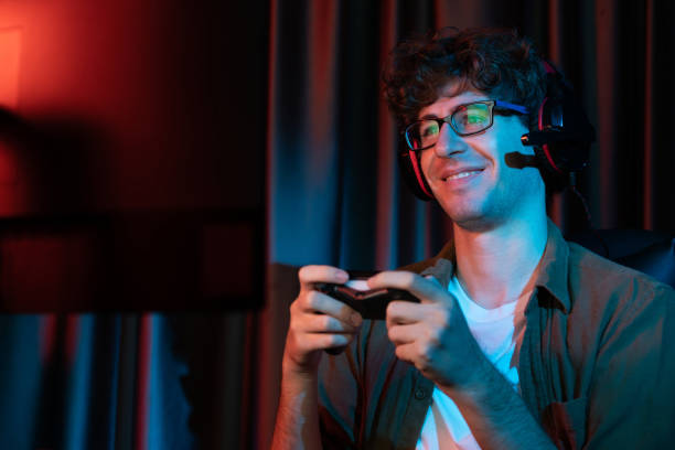 istock Smiling streamer with joystick, focusing Esport team on pc with harder. Gusher. 2163645169
