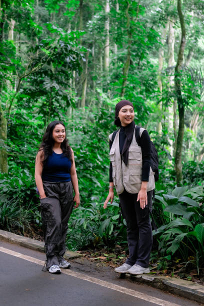 istock Joyful Conversations: Two Young Women Chatting in an Urban Forest 2163647015