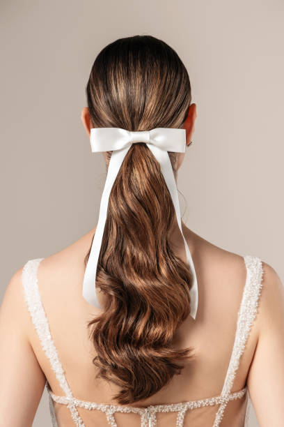 istock Elegant Hairstyle with White Ribbon Bow 2163647284