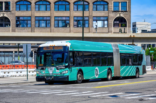 Detroit, USA - July 20, 2024: A Detroit Department of Transportation passenger bus drives on a city street in the downtown district.