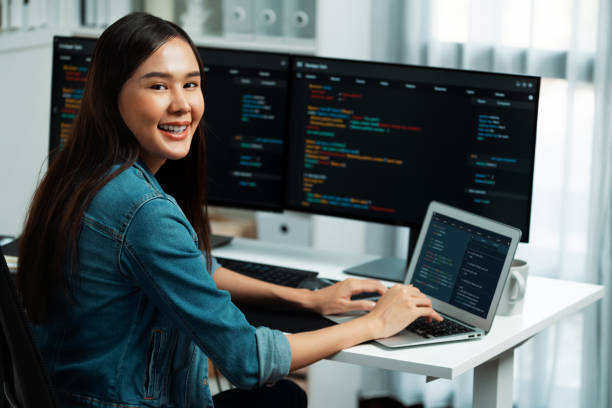istock Young Asian in IT developer looking at camera to present on pc. Stratagem. 2163648412