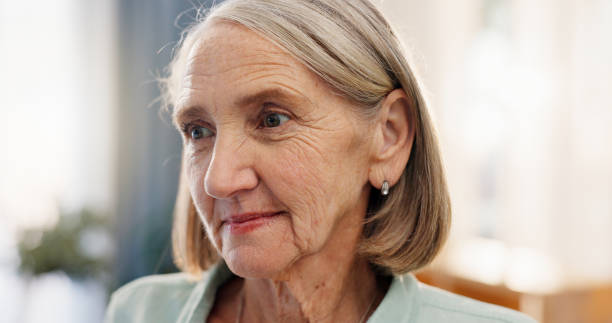 istock Old woman, thinking and relax in home, reflection and remember past life or memory in retirement. Female person, nostalgia and wondering in lounge, imagine future and contemplate choice or decision 2163649672