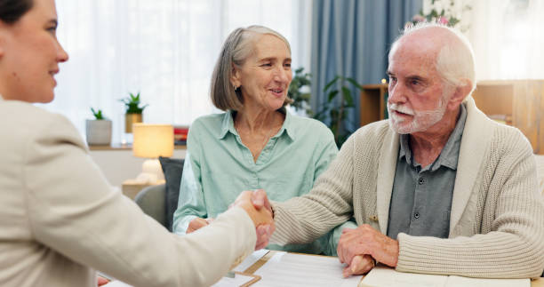 istock Home, old couple and consultant with handshake, retirement plan and conversation for negotiation. Financial meeting, man or woman in lounge, paperwork for legal agreement or will for final wishes 2163653823