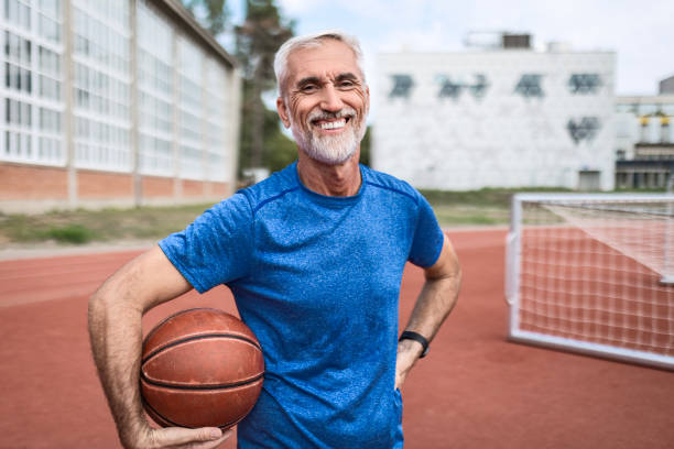 istock Mature Man Holding a Ball and Looking At Camera 2163657677