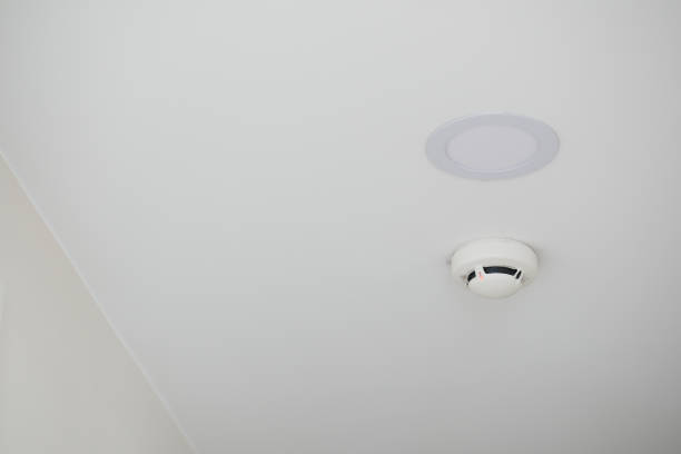 istock White smoke detector on ceiling at home 2163657679