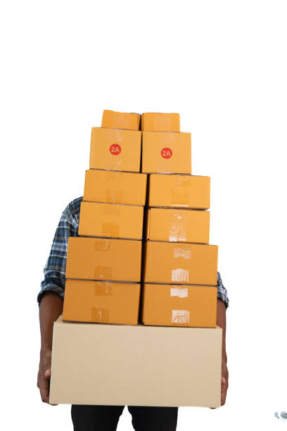 Unrecognizable young male warehouse worker holding a large box.