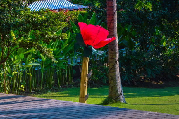 Colorful artificial flower decorations arranged beautifully in a garden setting, adding a vibrant and cheerful touch to the outdoor space