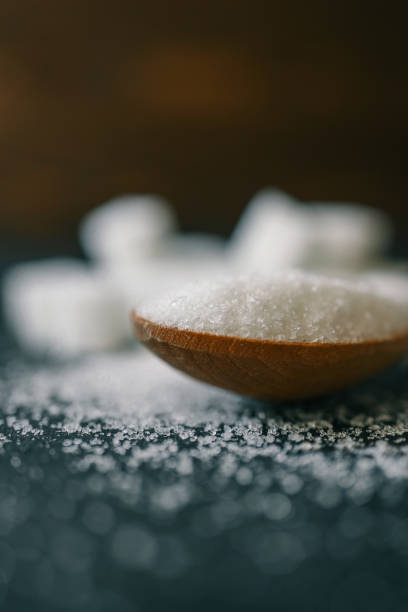 istock White crystalline sugar cubes on a wooden spoon 2163659150
