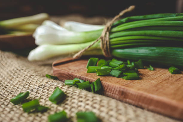 istock Fresh green onions on a cutting board 2163659324