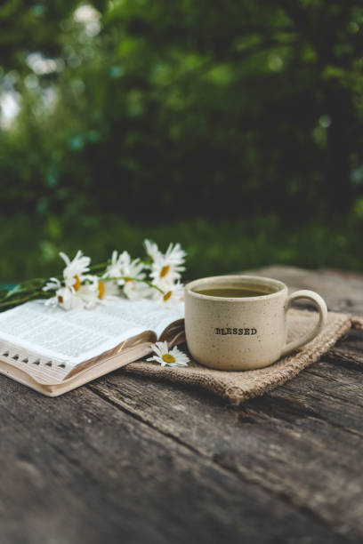 istock Cup with text BLESSED and open Bible in the garden, good morning 2163660075