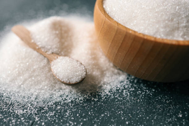 istock Wooden spoon with sugar on a plate 2163661932