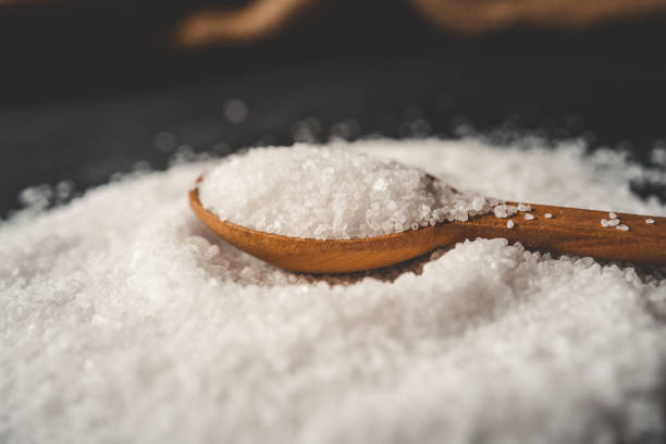 istock Wooden spoon with salt, splash, top view 2163661942