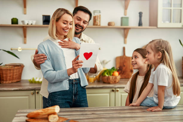 istock Family Reading Card In Kitchen 2163662803