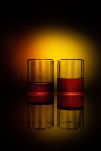 Five beautifully decorated candles stand on a table in a dark room on Halloween