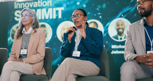 istock Stage, woman and presenter at seminar as event host, panel discussion or guest with microphone. Summit, public speaking and person with speech at conference for innovation in technology at workshop 2163665262