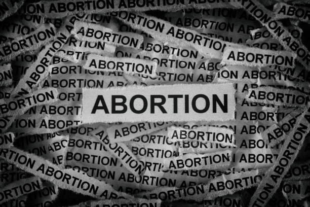 istock Strips of newspaper with the words Abortion typed on them 2163665318