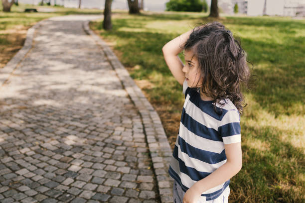 istock Happy, smiling boy with long hair at playground. 2163666817