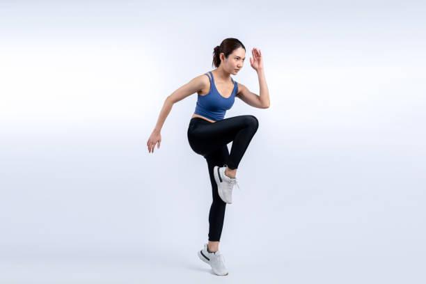istock Side view young athletic asian woman on running posture. Vigorous 2163667101