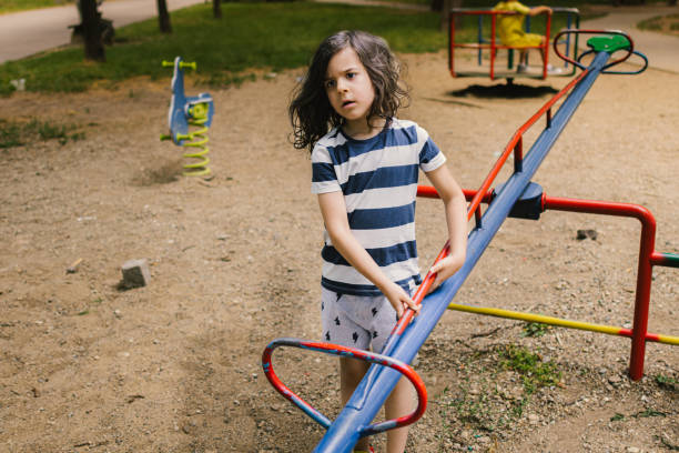 istock Happy, smiling boy with long hair at playground. 2163667312