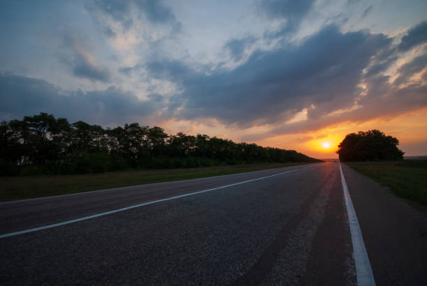 istock Asphalt road on sunset in the field. 2163667786