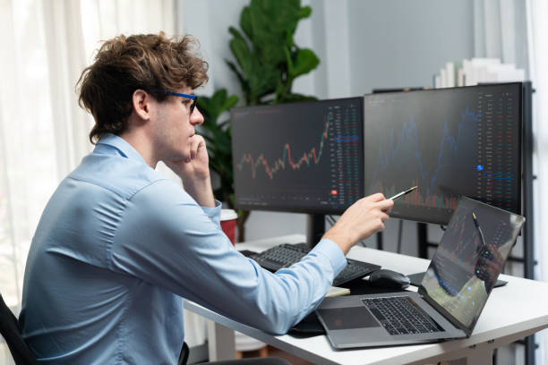 istock Working young business trader looking on laptop on laptop and pc. Gusher. 2163669171