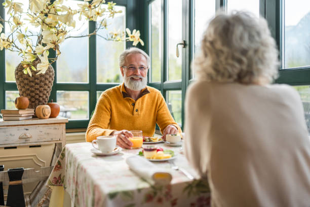 istock Senior Couple Breakfast in Cozy Hotel Setting 2163669370