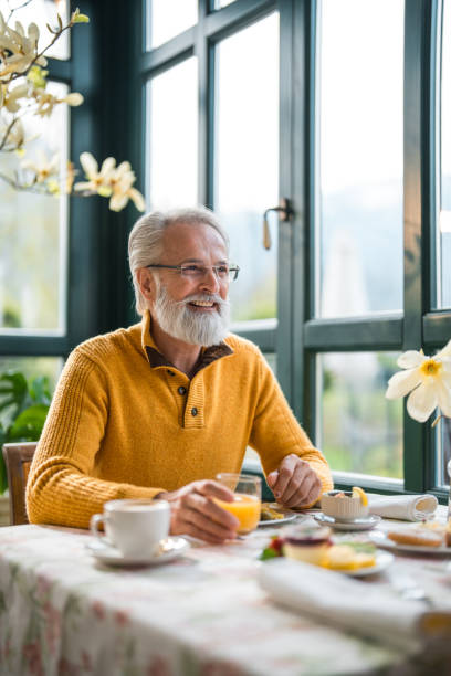 istock Elderly Gentleman Enjoying Morning Meal in Quaint Hotel Setting 2163669416