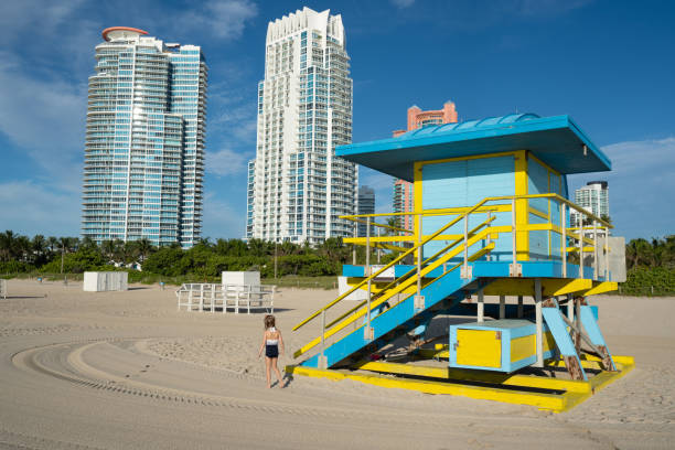 Young Girl on the Famous South Beach in the Early Morning with Calm Waves and Soft Sand in Miami, Florida USA Young girl on the Famous South Beach in the early morning with calm waves and soft sand in Miami, Florida USA 1 hotel south beach stock pictures, royalty-free photos & images