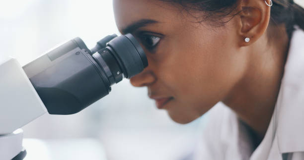 istock Studying, research and woman with microscope, science and sample for bacteria, cure and breakthrough. Person, scientist and employee with lab equipment, medical experiment and particles for vaccine 2163670126