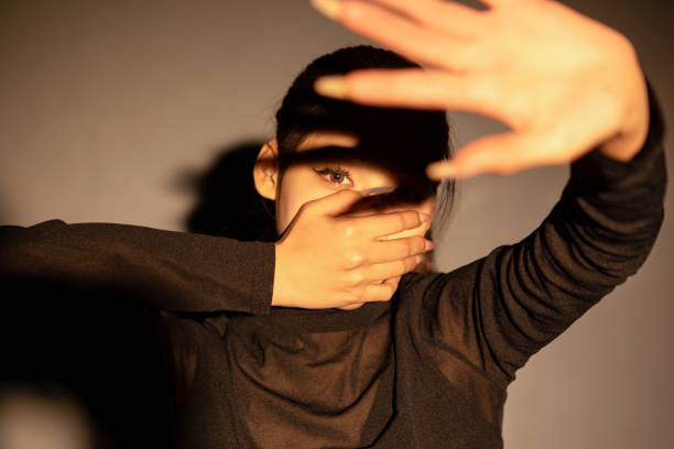 istock A girl covering her mouth 2163670460