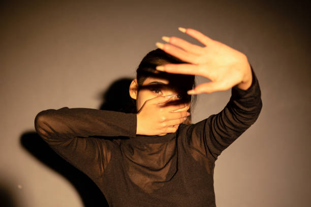 istock A girl covering her mouth 2163670486