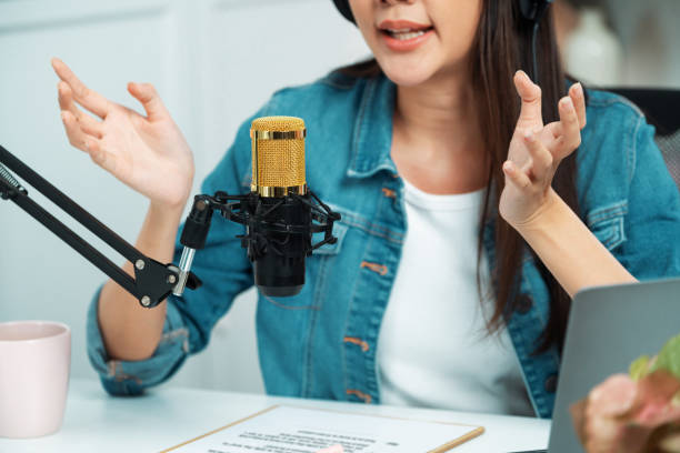 istock Host channel Asian in broadcast wearing headsets with script note. Stratagem. 2163670694