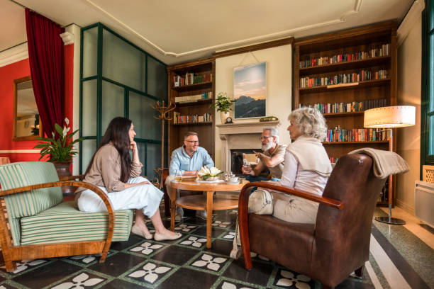 istock Joyful Caucasian Friends Gathering in Hotel Lounge 2163671753