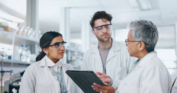 istock Science, research team and tablet discussion in lab, professional scientists and project for vaccine development. Talking, people and together for innovation medicine, microbiology and collaboration 2163671952
