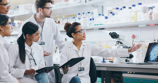 istock Laptop, science team and people learning for cancer cure, help or medical development in laboratory. Training, investigation or research info with scientists in clinical trial for medicine internship 2163672035