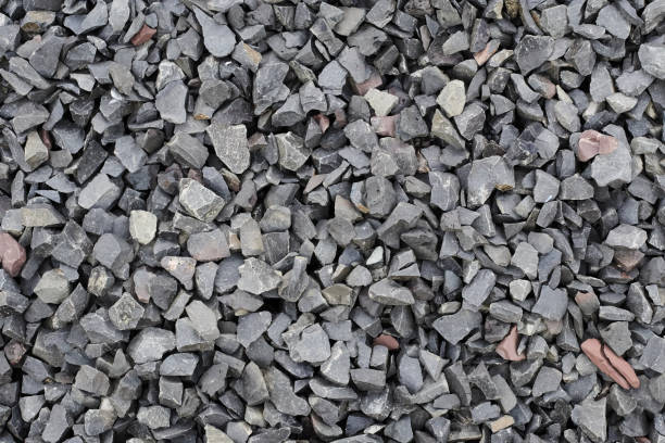 Quarry rubble. Crushed stone close up. Small rocks ground. Road building material and granite texture. Construction and road-making material. Garden blue stone gravel. Road base for pathway, driveway Crushed stone close up. Quarry rubble. Small rocks ground. Road building material and granite texture. Construction and road-making material. Garden blue stone gravel. Road base for pathway, driveway pebble driveway stock pictures, royalty-free photos & images