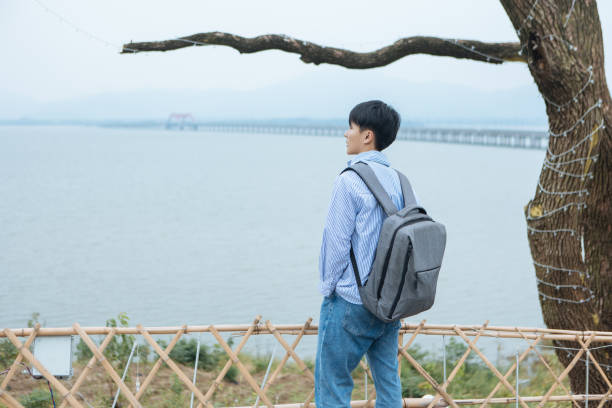 istock A man backpacker is enjoying the scenery while traveling outdoors 2163673984