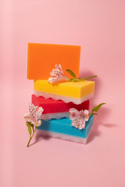 istock Creative arrangement from cleaning sponges with flowers on pastel pink background. Creative desinfection idea. 2163675886