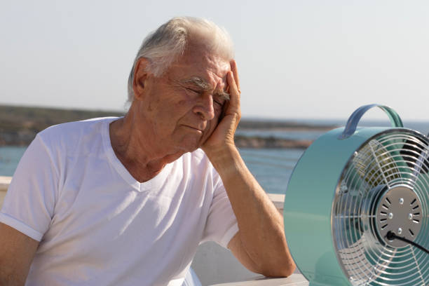 istock Elderly Man with Fan 2163677758