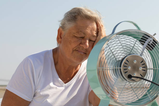 istock Elderly Woman with Fan 2163678324