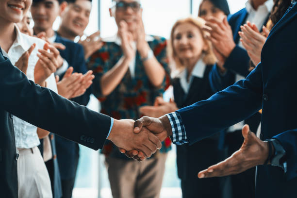 istock Cropped image of smart businessmen shaking hand, making agreement. Intellectual. 2163678599