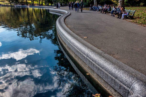 Conservatory Water is a picturesque and tranquil spot located in Central Park, New York City. The large, classically-designed pond was originally intended to be part of a formal conservatory, hence its name, but the conservatory was never built. Instead, the area became known for its use as a model boat pond, where enthusiasts could sail their miniature, remote-controlled boats. The area around Conservatory Water is surrounded by benches and walking paths, making it an ideal place for a leisurely stroll, reading, or simply enjoying the serene environment