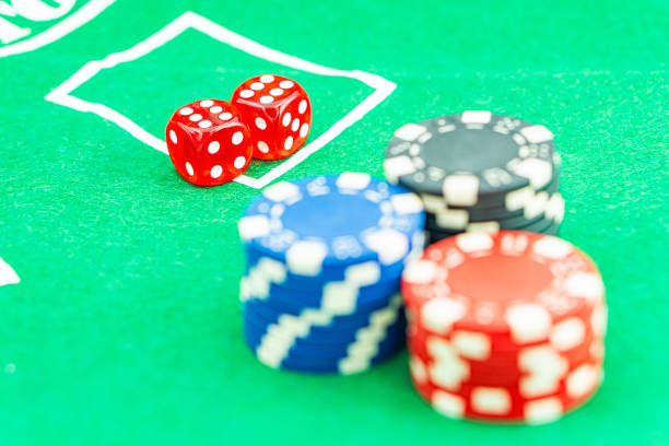 Vivid dice displaying the number six, contrast beautifully against a vibrant blue backdrop