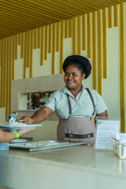 female kitchen staff in hotel serving lunch smiling